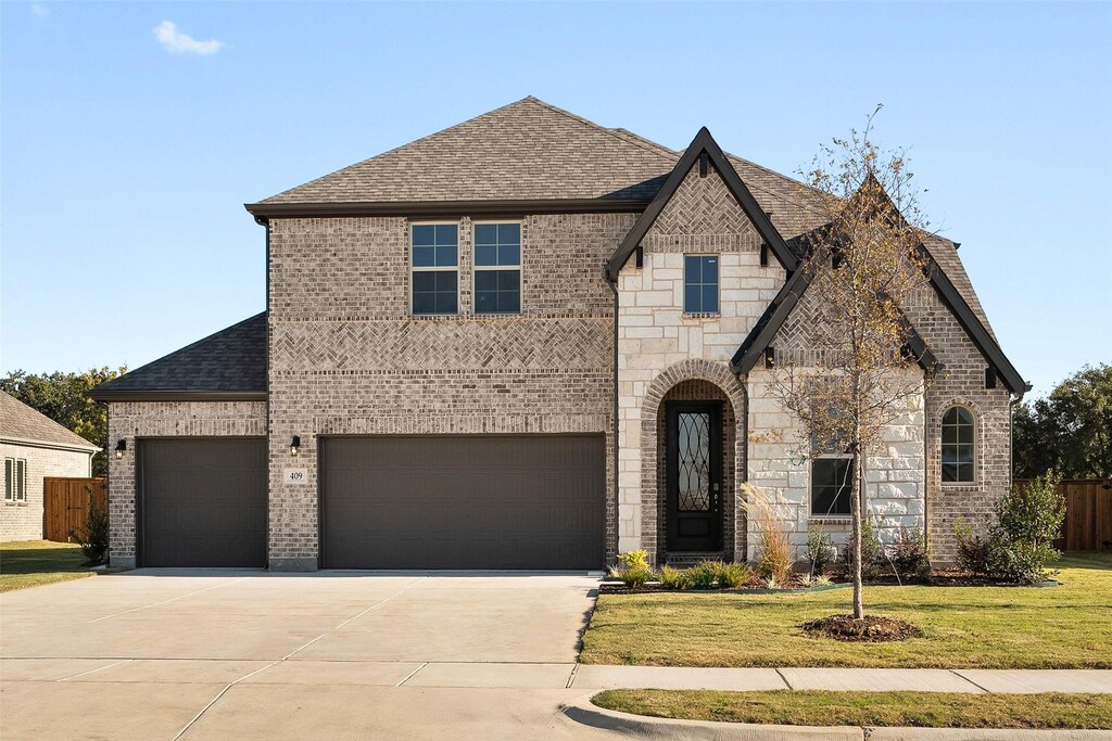 view of front of house with a garage and a front yard