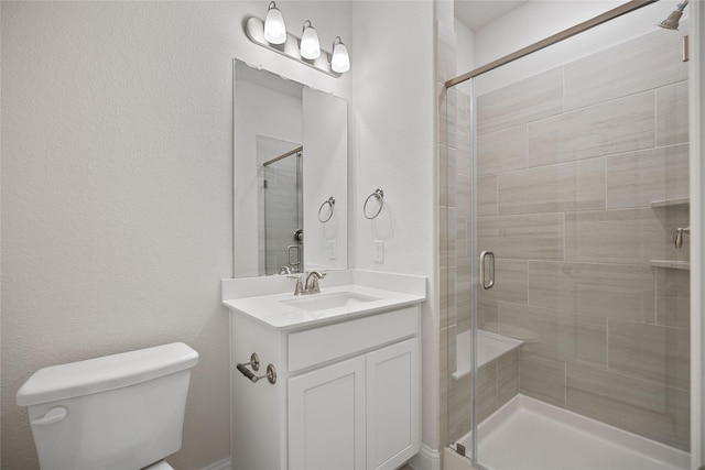 bathroom with vanity, toilet, and an enclosed shower