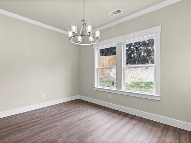 spare room with ornamental molding, dark hardwood / wood-style flooring, and a notable chandelier