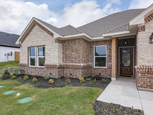 property entrance with a lawn