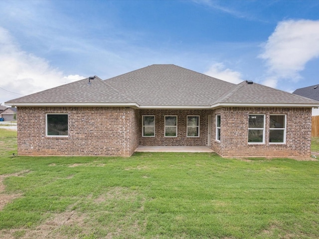 rear view of house with a yard and a patio area