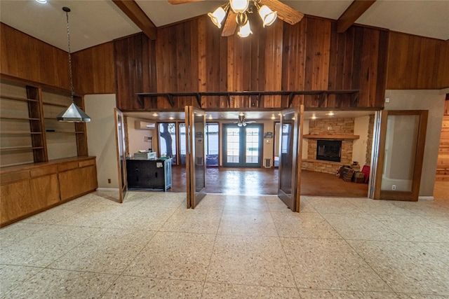 tiled living room featuring wood walls, high vaulted ceiling, beam ceiling, and ceiling fan