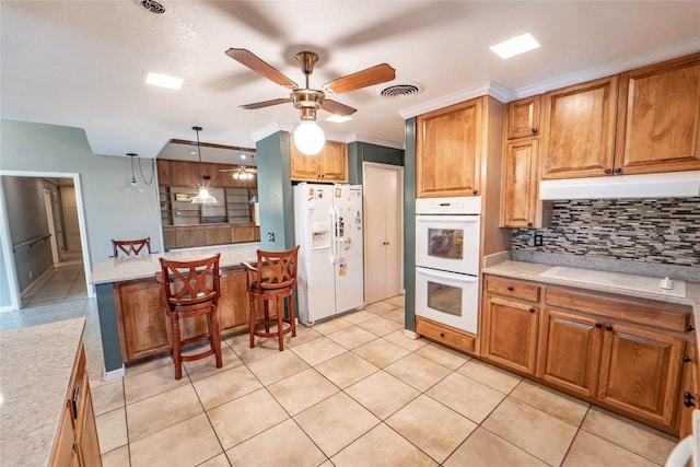 kitchen featuring pendant lighting, ceiling fan, white appliances, and light tile floors