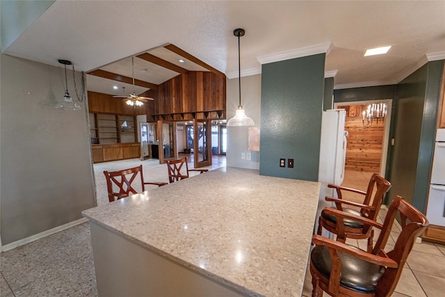 kitchen featuring hanging light fixtures, ceiling fan, light stone countertops, and light tile floors