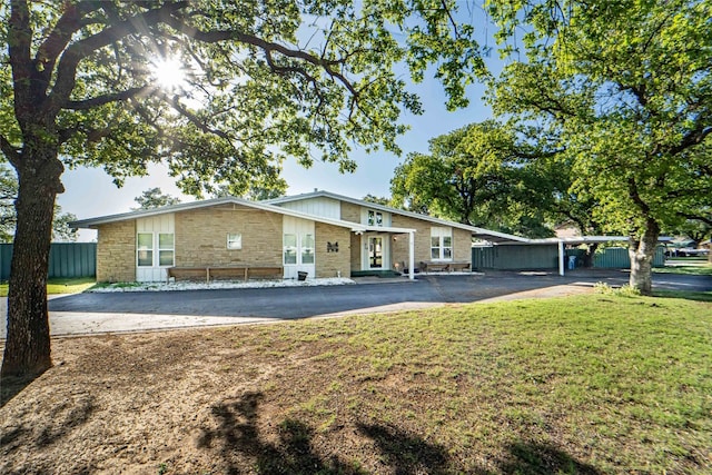 rear view of property featuring a lawn