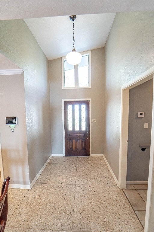 tiled entryway featuring lofted ceiling