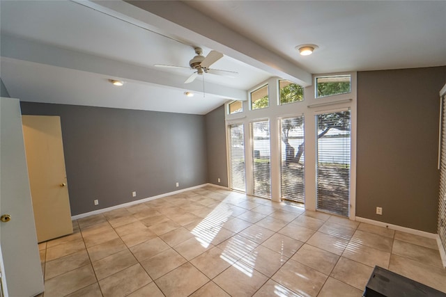 tiled empty room with ceiling fan and lofted ceiling with beams