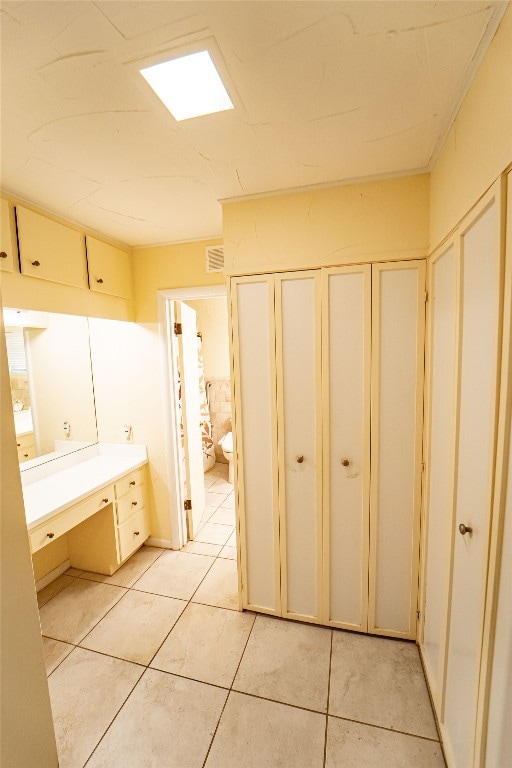 bathroom with tile flooring and vanity