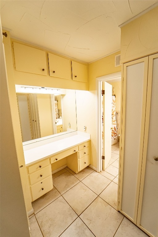 bathroom with tile flooring and vanity