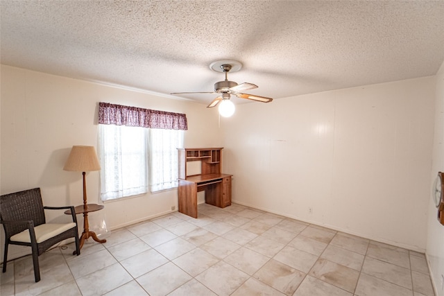 sitting room featuring ceiling fan, light tile floors, and a textured ceiling