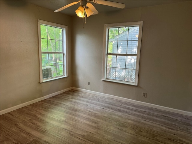 unfurnished room featuring hardwood / wood-style floors and ceiling fan