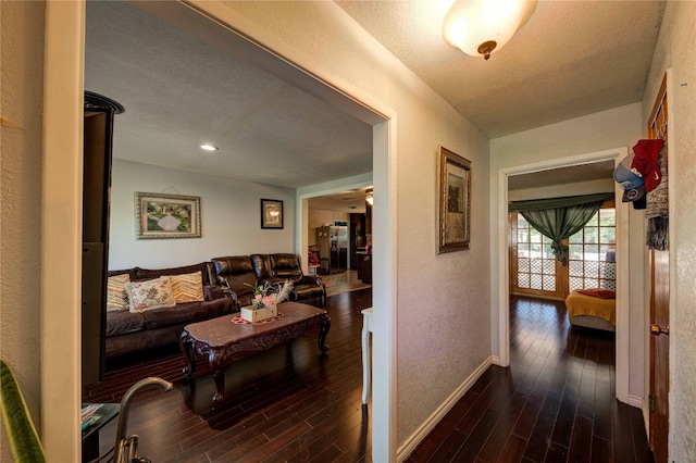 interior space featuring dark hardwood / wood-style flooring and a textured ceiling