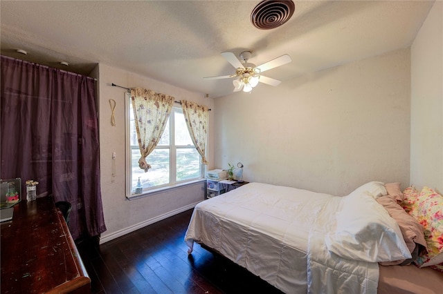 bedroom featuring ceiling fan and dark hardwood / wood-style flooring