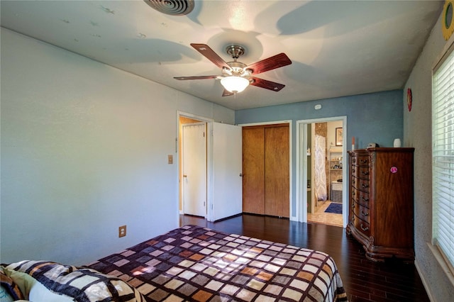 unfurnished bedroom with ensuite bath, a closet, ceiling fan, and dark hardwood / wood-style floors