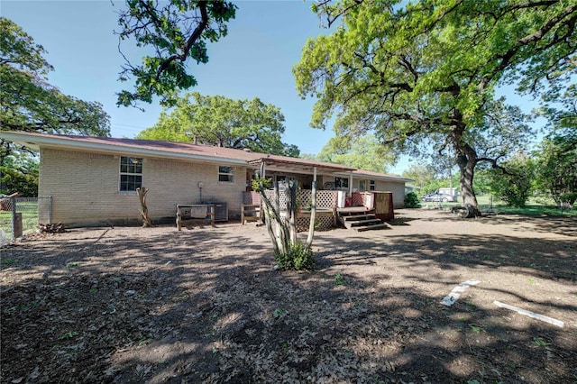 rear view of house with a wooden deck