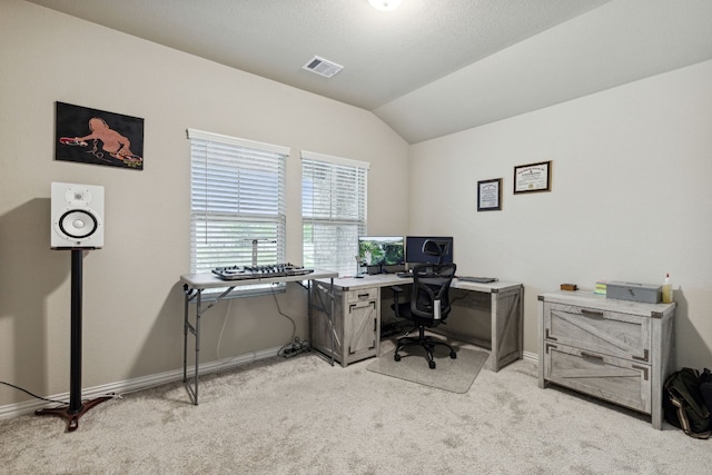 office with light colored carpet and vaulted ceiling