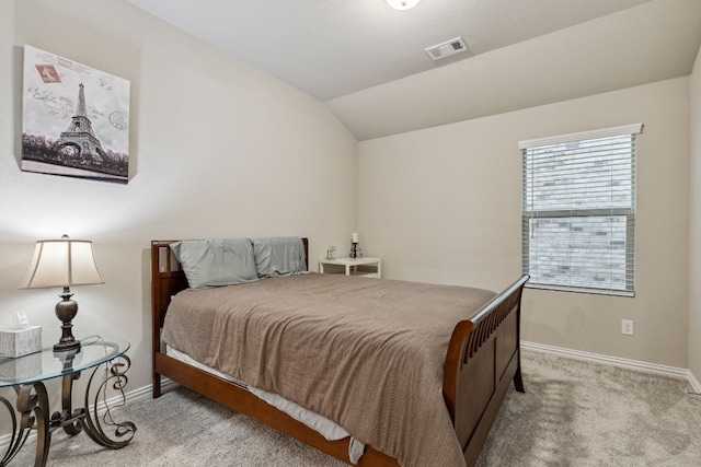 carpeted bedroom featuring lofted ceiling