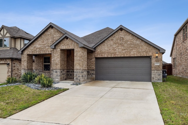 view of front of house with a garage and a front lawn