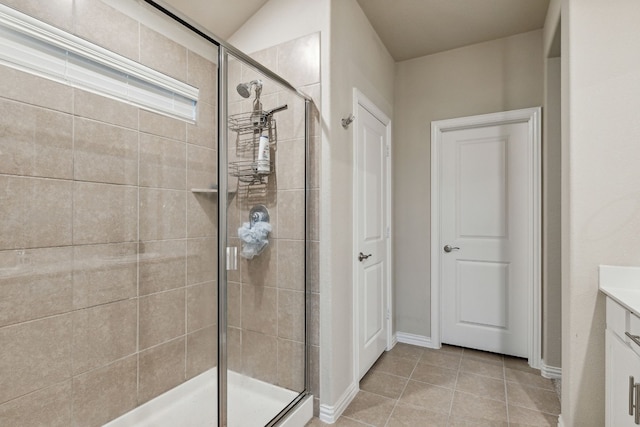 bathroom featuring walk in shower, vanity, and tile flooring