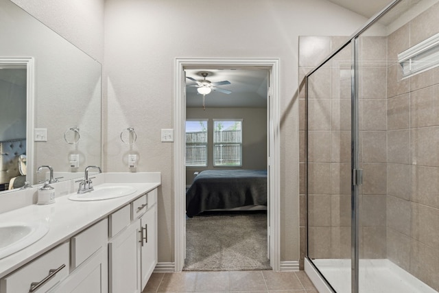 bathroom with tile flooring, ceiling fan, a shower with shower door, and dual bowl vanity