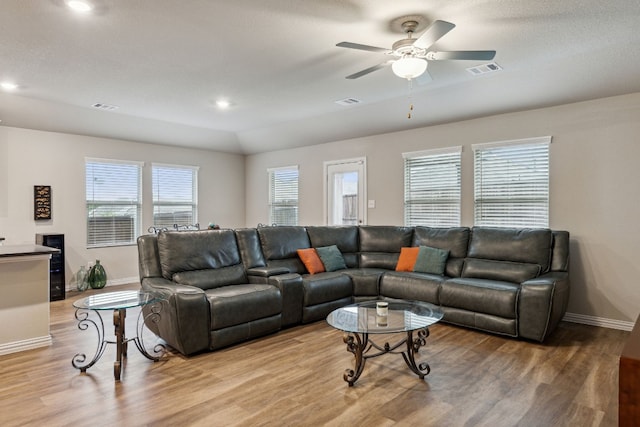 living room featuring ceiling fan and light hardwood / wood-style floors