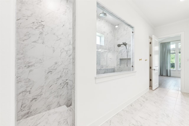 bathroom featuring tiled shower and ornamental molding