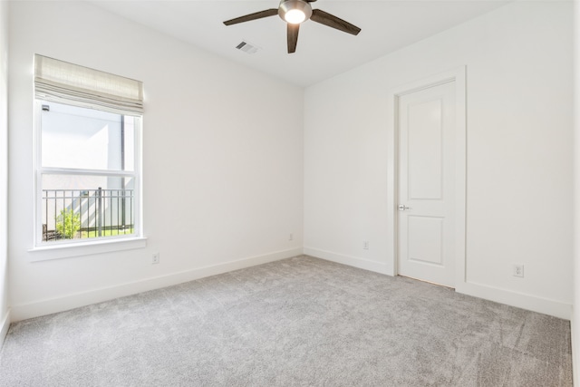 carpeted empty room featuring ceiling fan