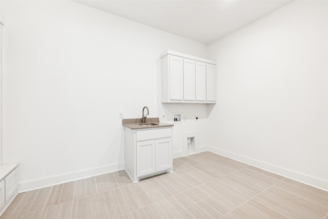 clothes washing area featuring cabinets, sink, washer hookup, and hookup for an electric dryer