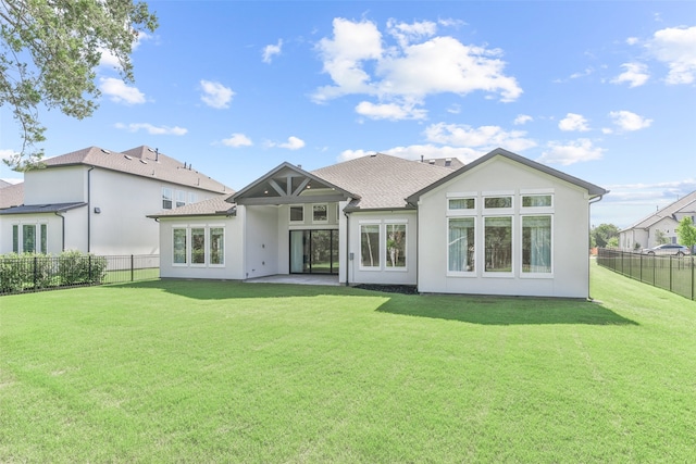 back of property with a lawn and a patio area