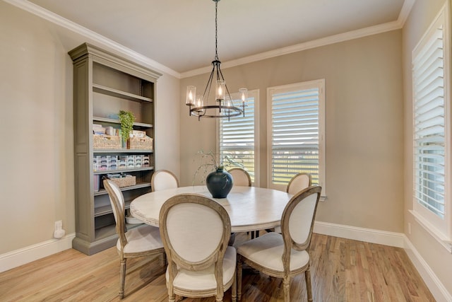 dining room with light wood-type flooring, a chandelier, and ornamental molding