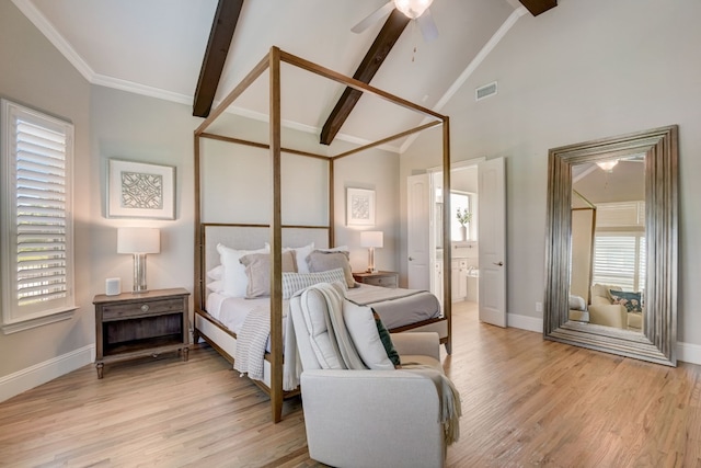 bedroom with lofted ceiling with beams, light hardwood / wood-style flooring, ceiling fan, connected bathroom, and multiple windows