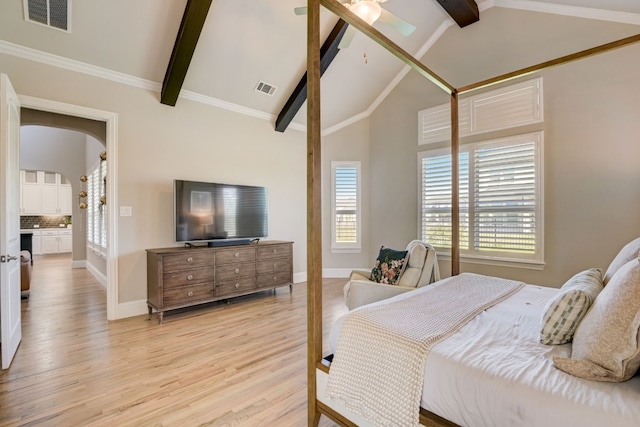 bedroom with light hardwood / wood-style floors, lofted ceiling with beams, ensuite bath, and ceiling fan