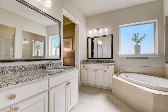 bathroom featuring tile patterned flooring, vanity, and shower with separate bathtub