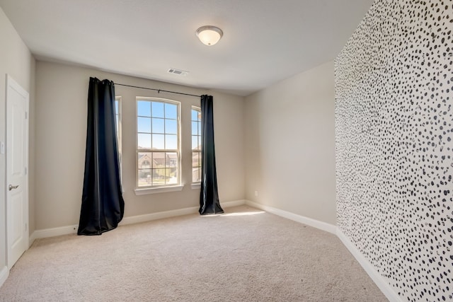 unfurnished room with light carpet