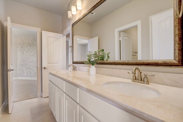 bathroom featuring tile patterned floors and vanity