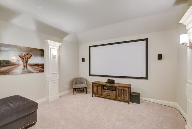 carpeted home theater featuring decorative columns