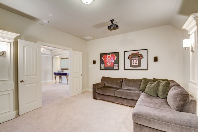 carpeted living room featuring lofted ceiling