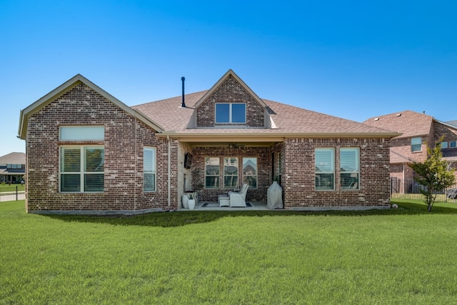 rear view of property featuring a yard and a patio