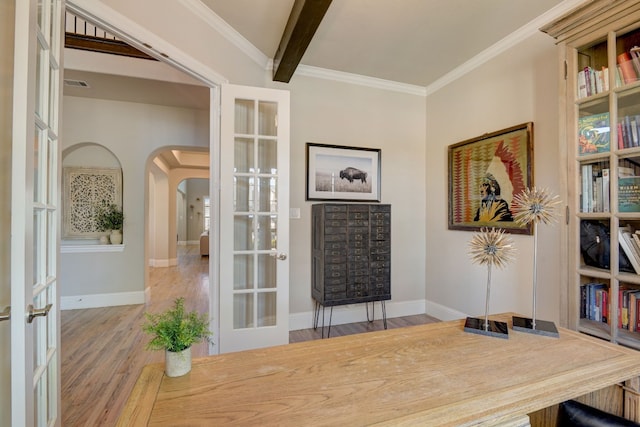 office area with beam ceiling, light hardwood / wood-style flooring, crown molding, and french doors