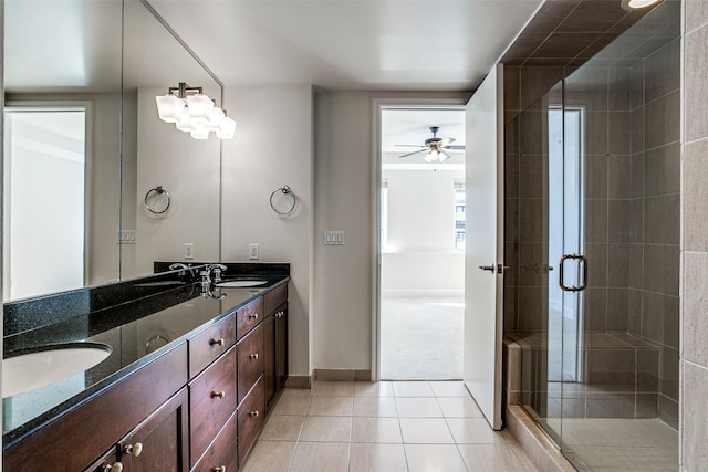 bathroom with vanity with extensive cabinet space, an enclosed shower, double sink, tile flooring, and ceiling fan