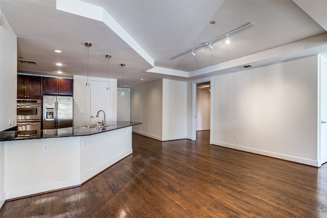 kitchen with decorative light fixtures, stainless steel appliances, dark hardwood / wood-style floors, dark brown cabinetry, and sink