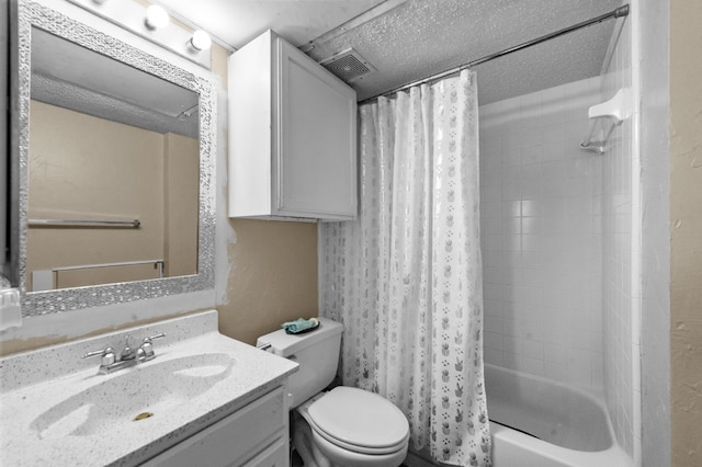 full bathroom featuring shower / tub combo with curtain, vanity, toilet, and a textured ceiling