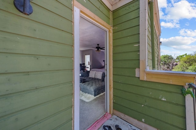 view of exterior entry with ceiling fan