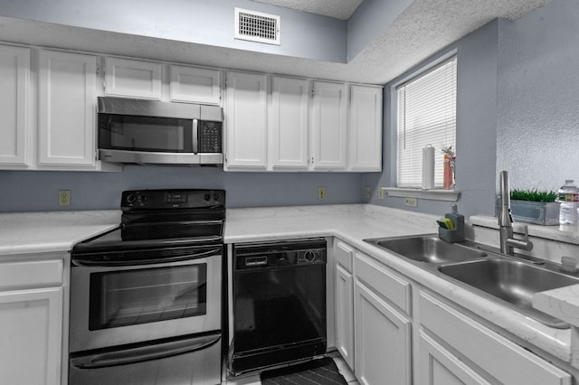 kitchen with stainless steel appliances, white cabinets, sink, and light stone countertops