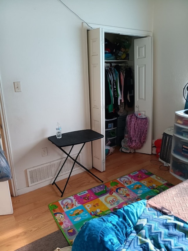 bedroom with a closet and hardwood / wood-style flooring