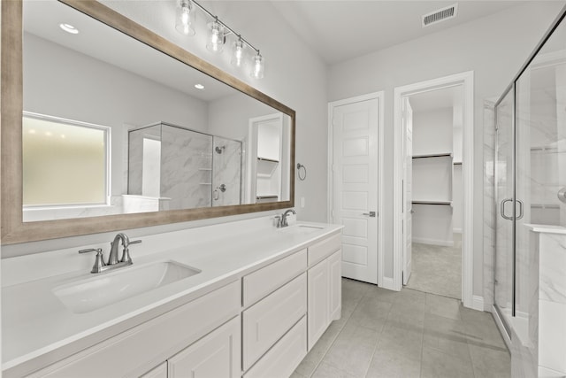 bathroom with vanity and a shower with shower door