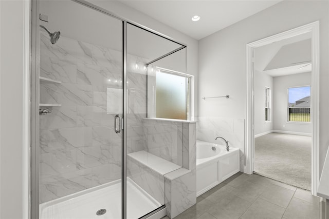 bathroom featuring tile patterned flooring and separate shower and tub