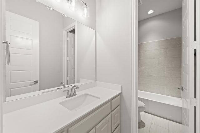 full bathroom featuring tiled shower / bath combo, vanity, and toilet