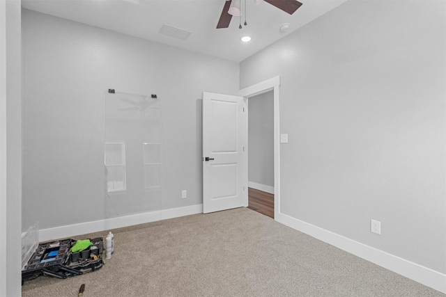 unfurnished room featuring ceiling fan and carpet flooring