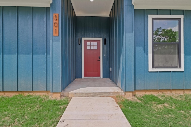 doorway to property with a yard